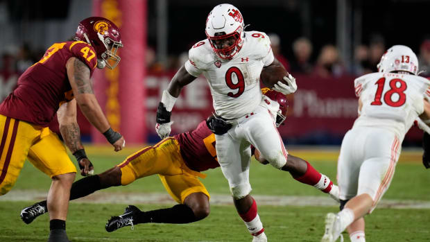 Oct 9, 2021; Los Angeles, California, USA; Utah Utes running back Tavion Thomas (9) breaks away from USC Trojans safety Isaiah Pola-Mao (21) during the fourth quarter at United Airlines Field at Los Angeles Memorial Coliseum. Mandatory Credit: Robert Hanashiro-USA TODAY Sports